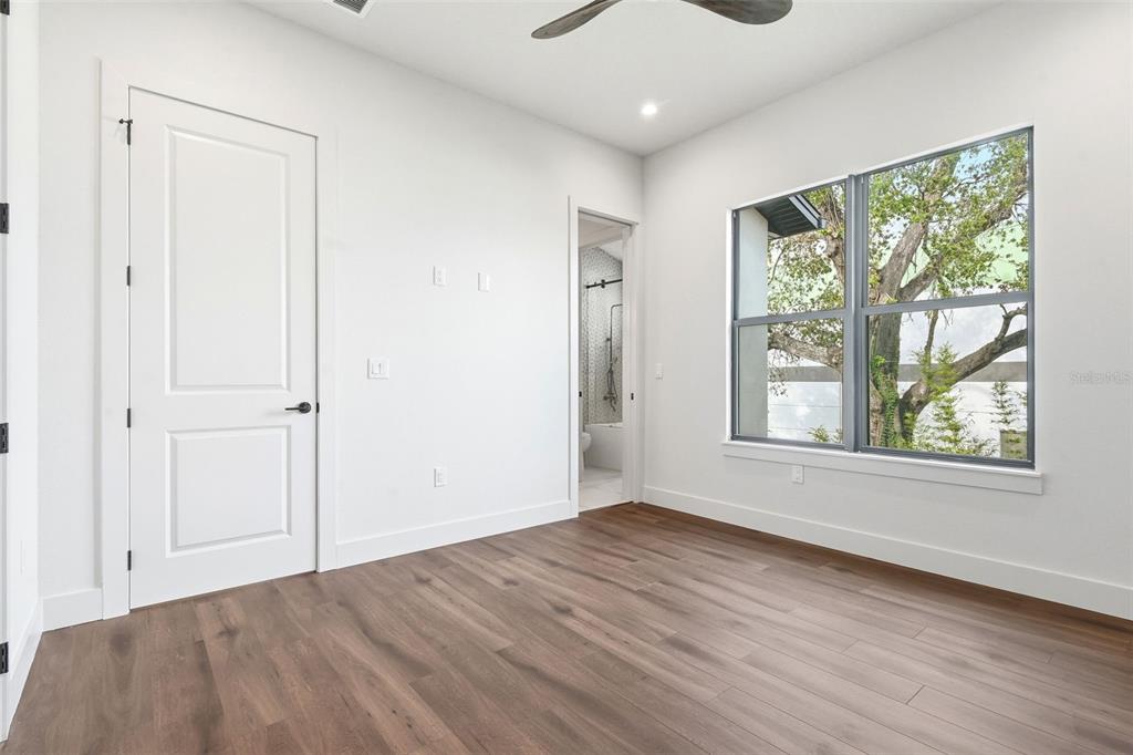 1615 Cole Road Orlando, FL 32803 - Photo 27 of 31 an empty room with wooden floor and windows
