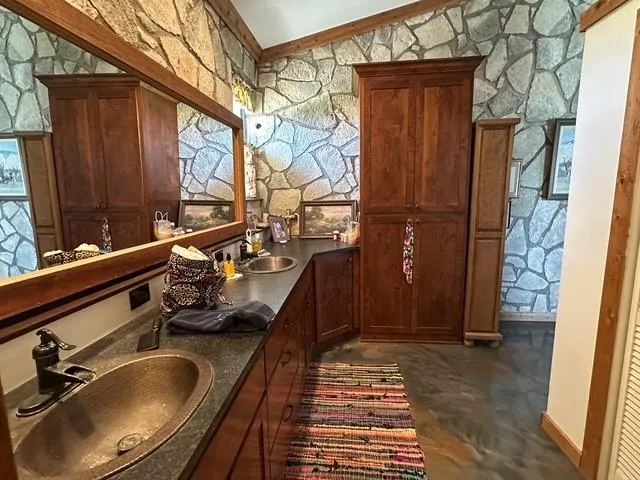 a spacious bathroom with a double vanity sink and a mirror