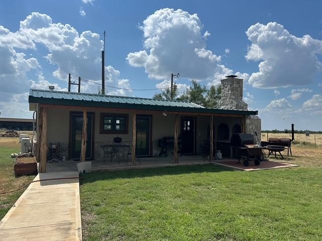 1815 Ranch To Market Road 2597 Sonora, TX 76950 - Photo 17 of 32 a view of a house with a backyard and a patio