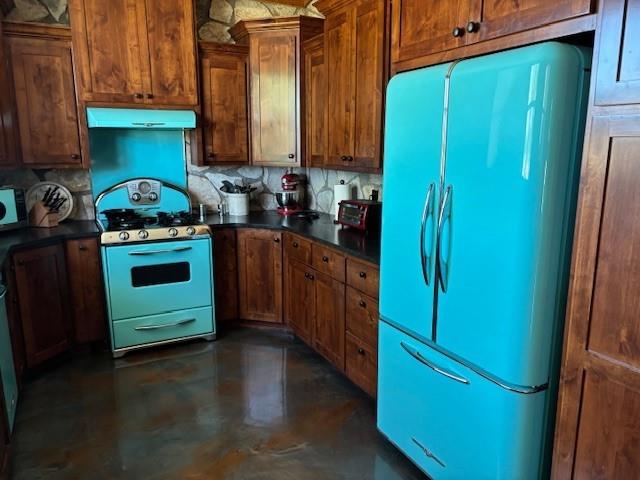 1815 Ranch To Market Road 2597 Sonora, TX 76950 - Photo 8 of 32 a kitchen with stainless steel appliances granite countertop a refrigerator and a stove