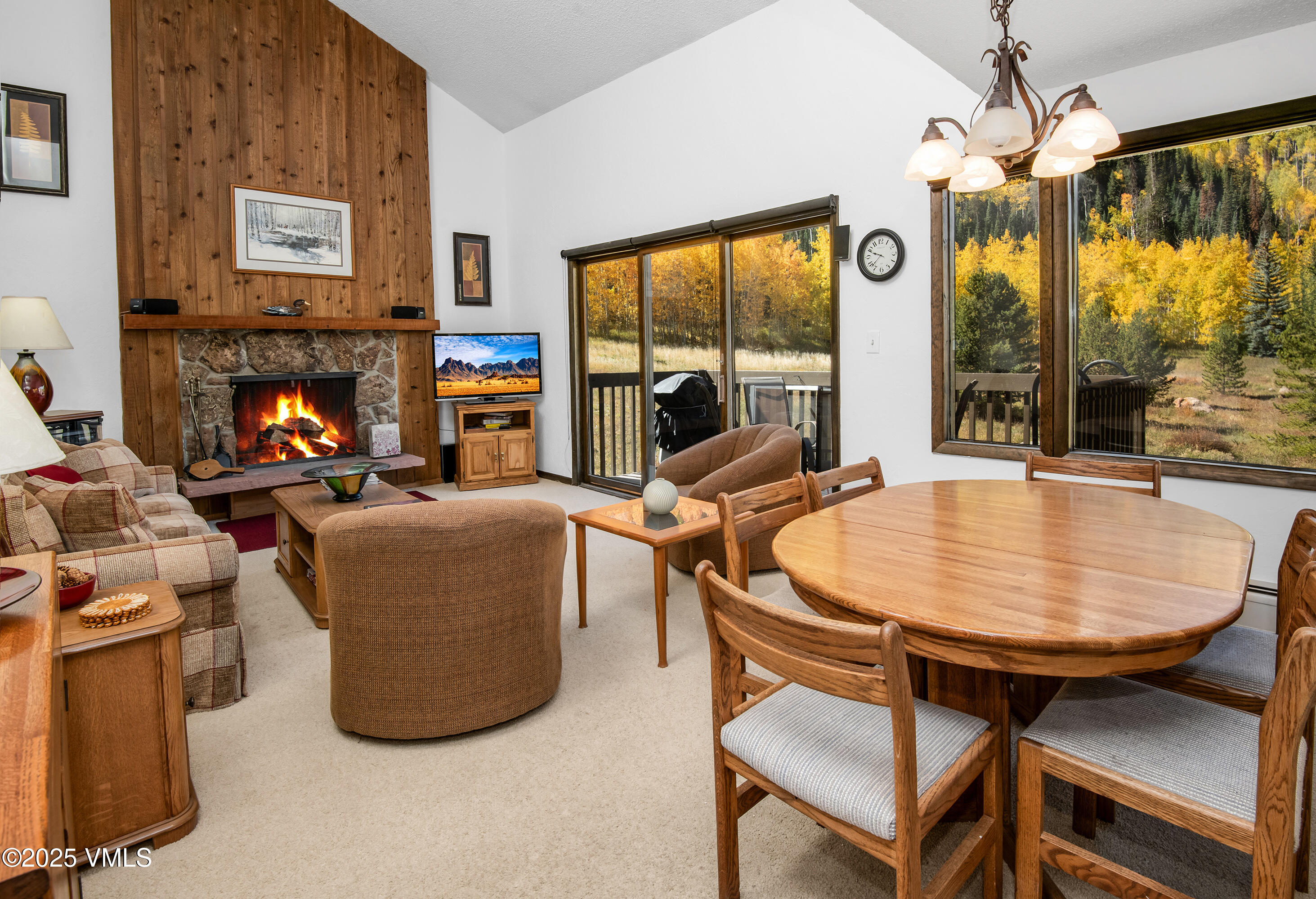 a living room with furniture a large window and a fireplace