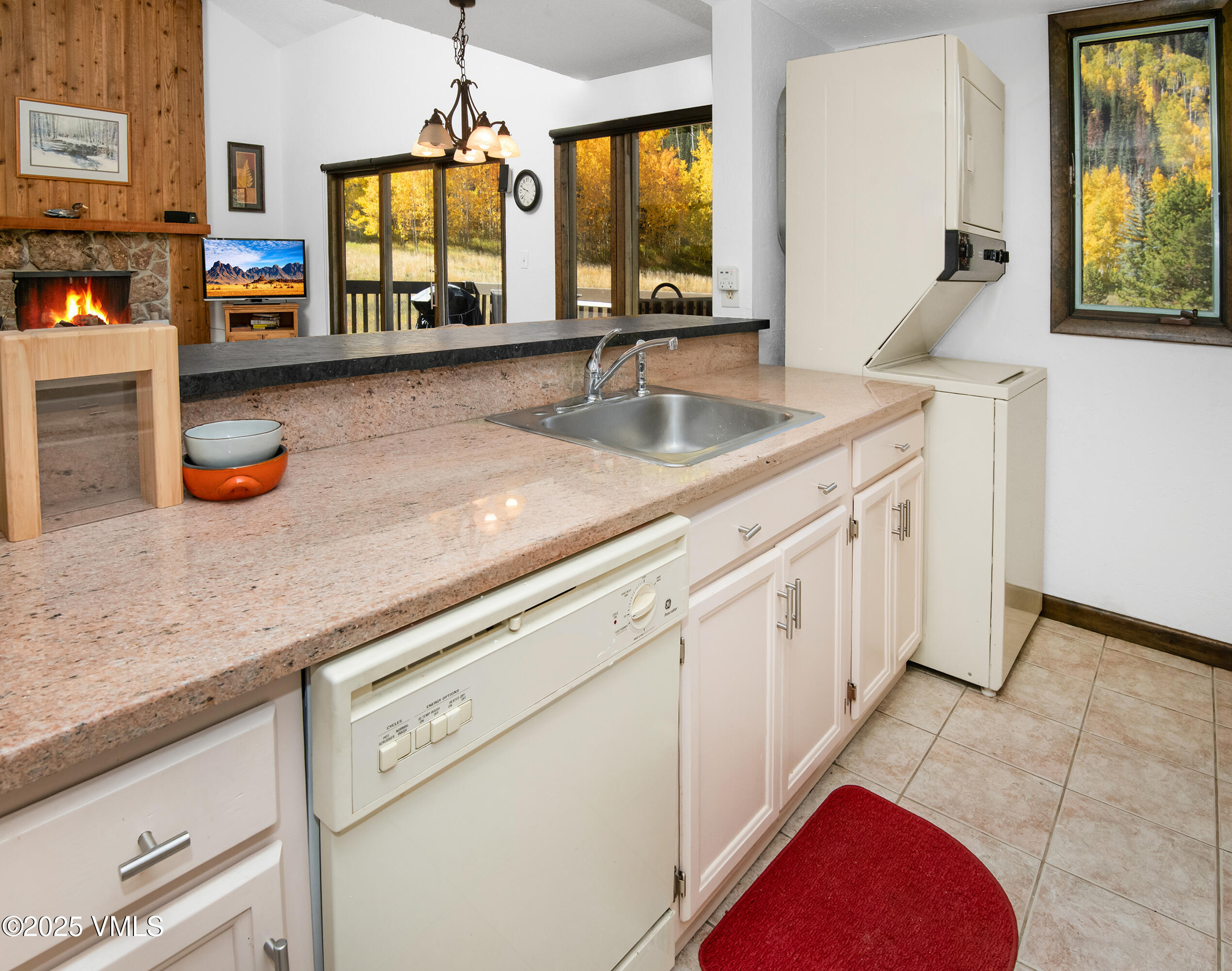 4516 Meadow Drive, Unit 807 Vail, CO 81657 - Photo 12 of 35 a kitchen with stainless steel appliances granite countertop a sink window and cabinets