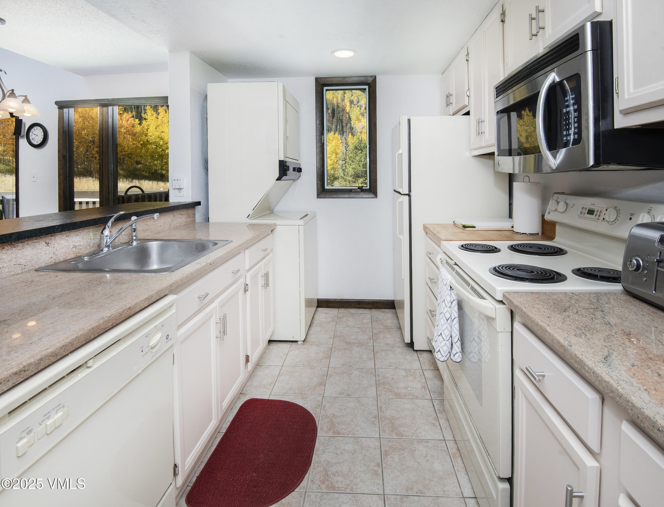 4516 Meadow Drive, Unit 807 Vail, CO 81657 - Photo 13 of 35 a kitchen with stainless steel appliances granite countertop a sink stove and refrigerator