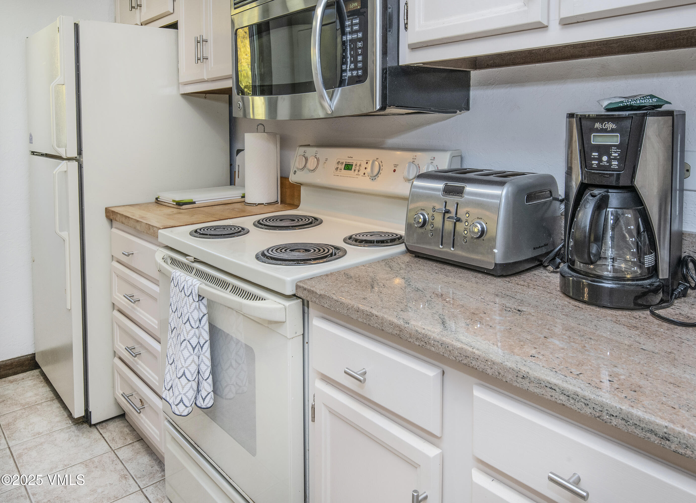 4516 Meadow Drive, Unit 807 Vail, CO 81657 - Photo 14 of 35 a kitchen with a stove and cabinets