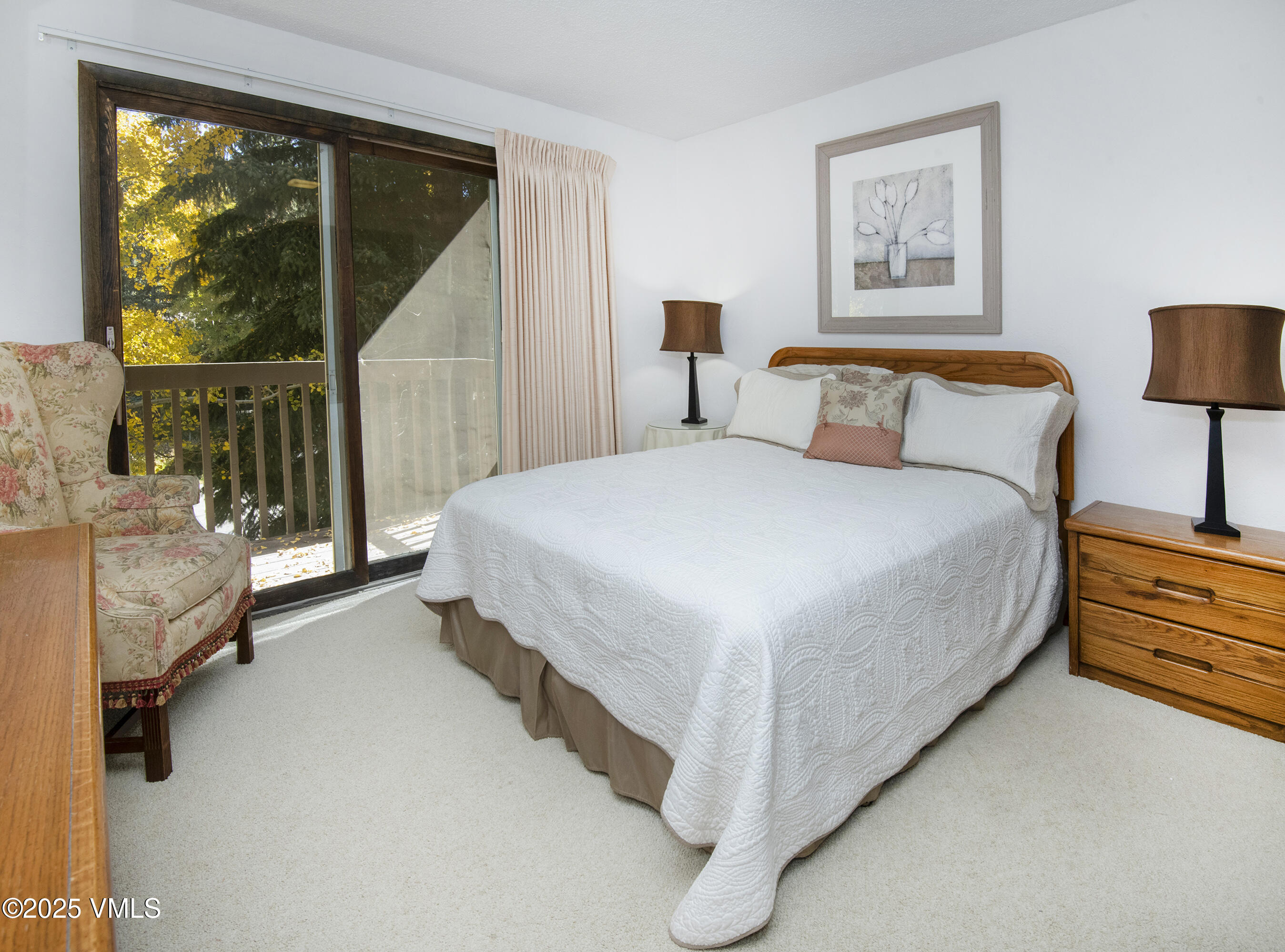 4516 Meadow Drive, Unit 807 Vail, CO 81657 - Photo 17 of 35 a bed room with a bed and a night stand