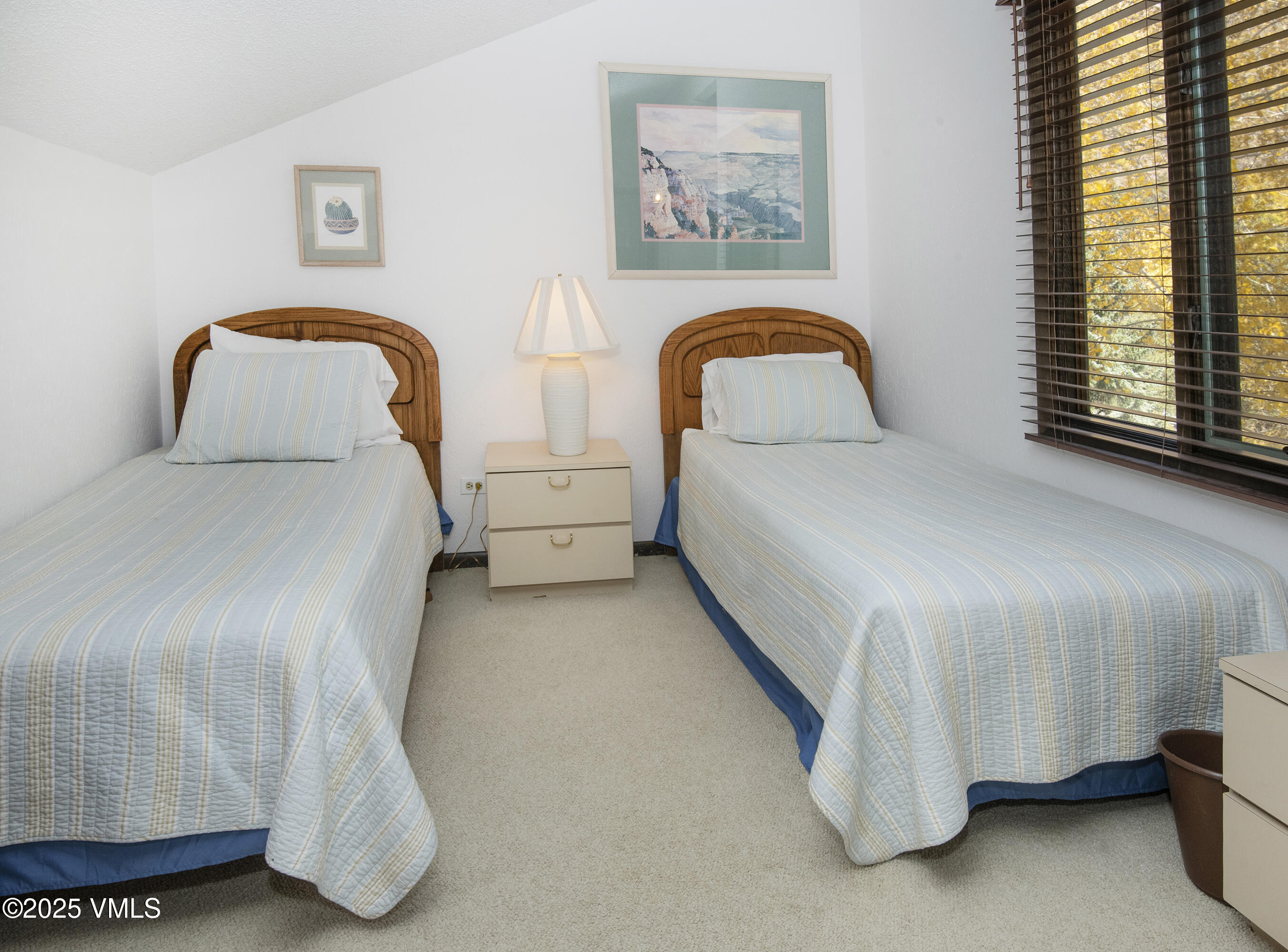 4516 Meadow Drive, Unit 807 Vail, CO 81657 - Photo 19 of 35 a bedroom with a bed and a painting on the wall