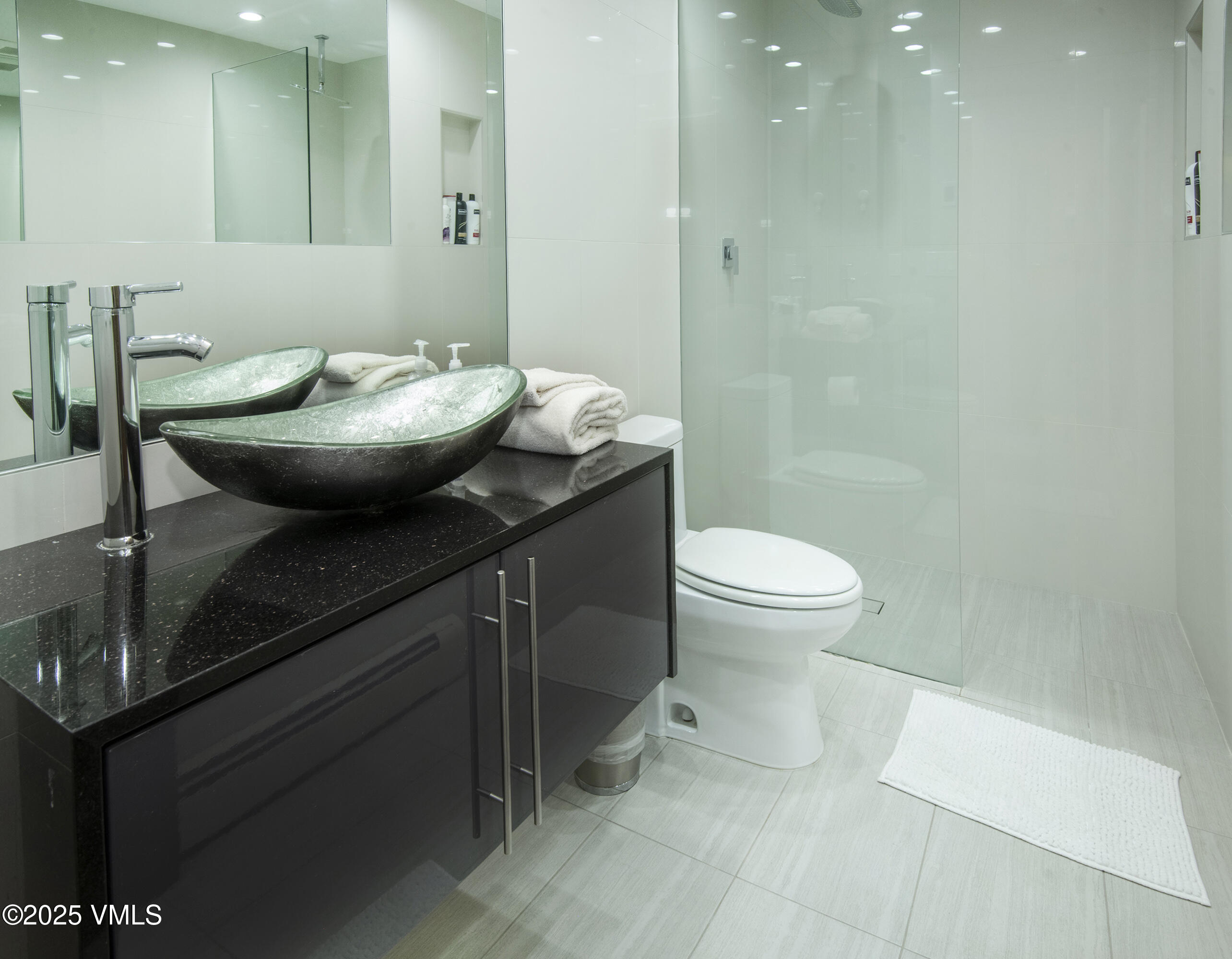 4516 Meadow Drive, Unit 807 Vail, CO 81657 - Photo 20 of 35 a bathroom with a sink a toilet and a mirror