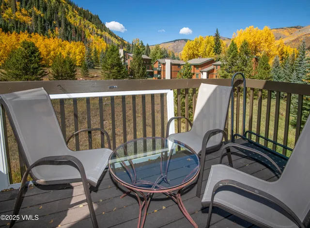 an aerial view of a house with a yard and trees