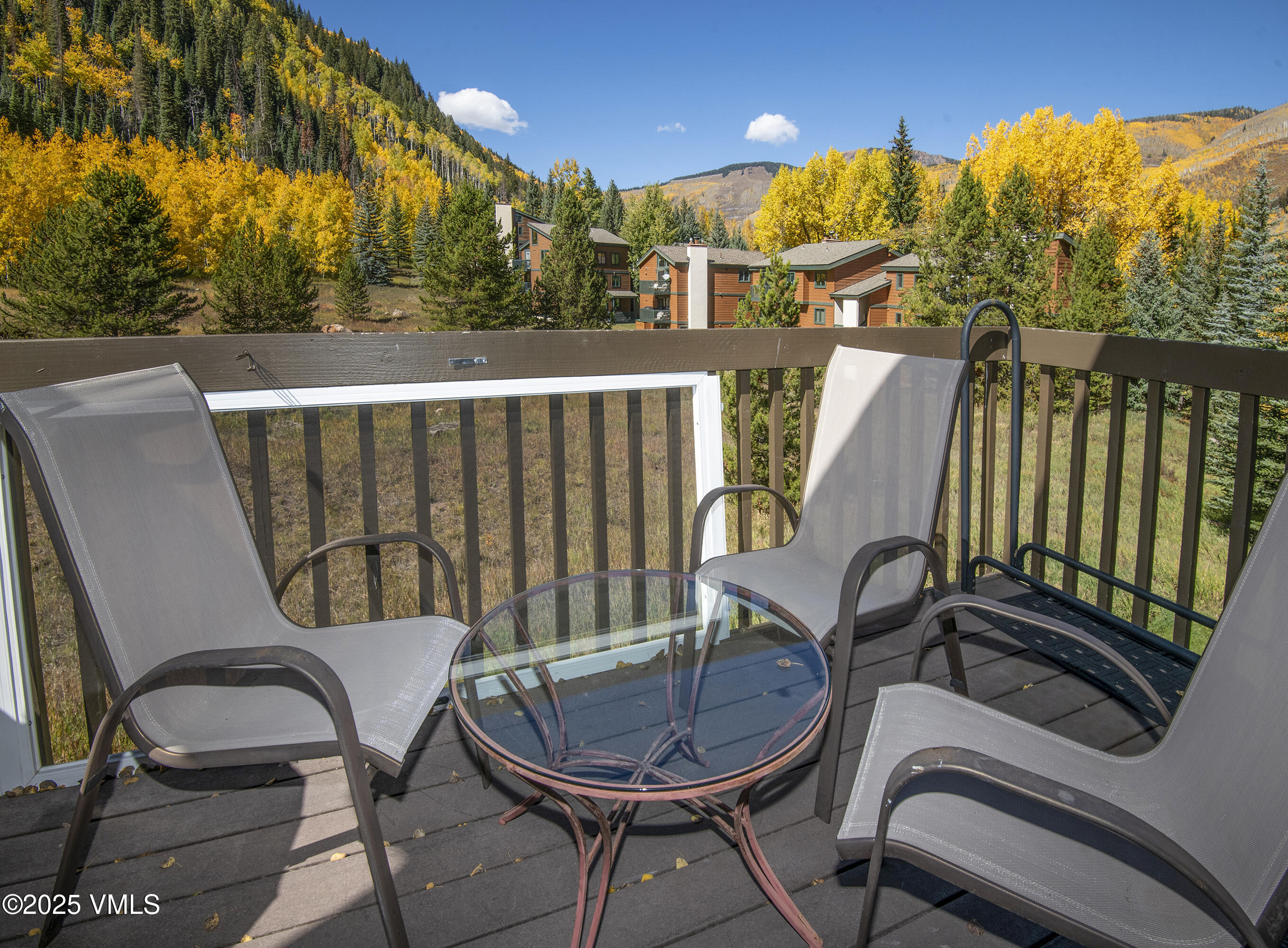 4516 Meadow Drive, Unit 807 Vail, CO 81657 - Photo 23 of 35 a view of a chair and tables in the balcony