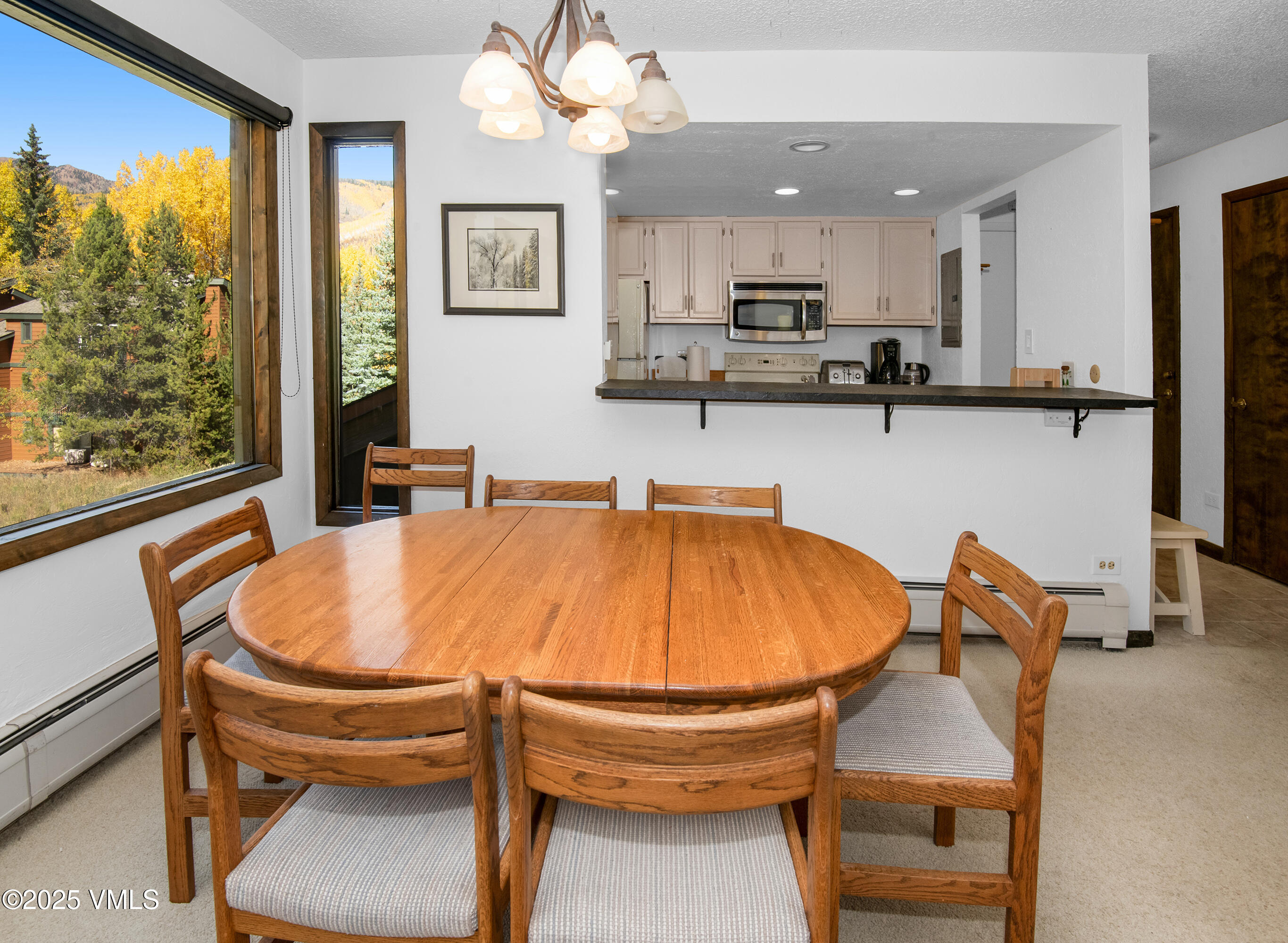 4516 Meadow Drive, Unit 807 Vail, CO 81657 - Photo 6 of 35 a dining table sitting next to a window
