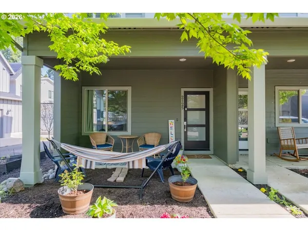 a front view of a house with garden and sitting area
