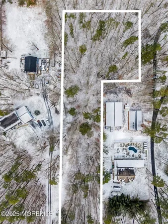 a front view of a house with a yard fire pit and outdoor seating