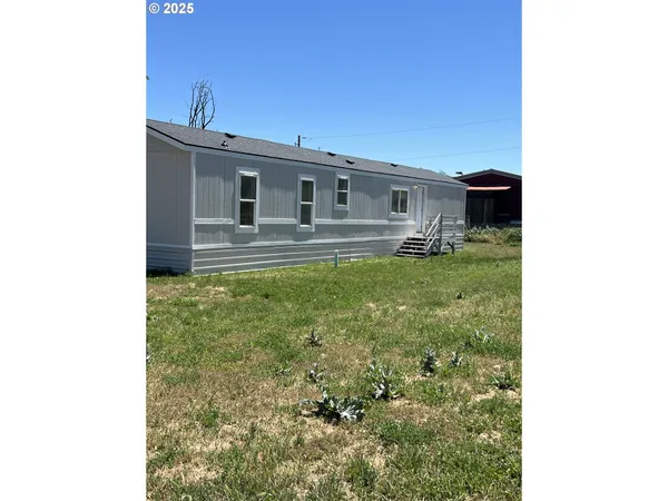 a backyard of a house with table and chairs