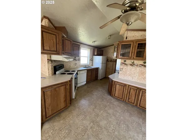 a kitchen with stainless steel appliances granite countertop a sink and cabinets