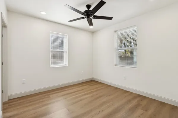 a view of a livingroom with a ceiling fan and window