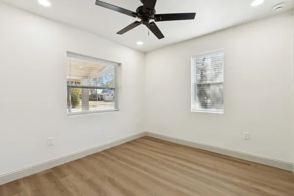 wooden floor in an empty room with a window