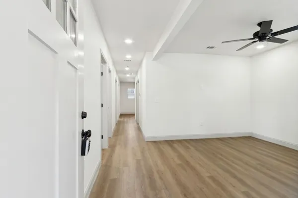 a view of a room with wooden floor