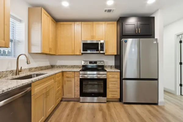 a kitchen with a refrigerator sink and microwave