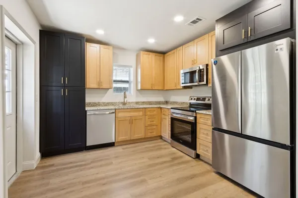 a kitchen with a refrigerator sink and microwave