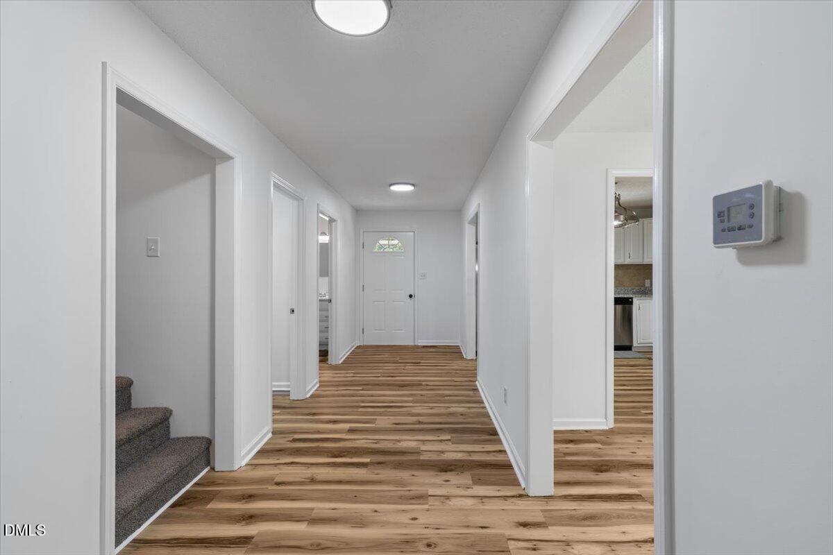 836 South Main Street Roxboro, NC 27573 - Photo 13 of 55 a view of a hallway with wooden floor and staircase