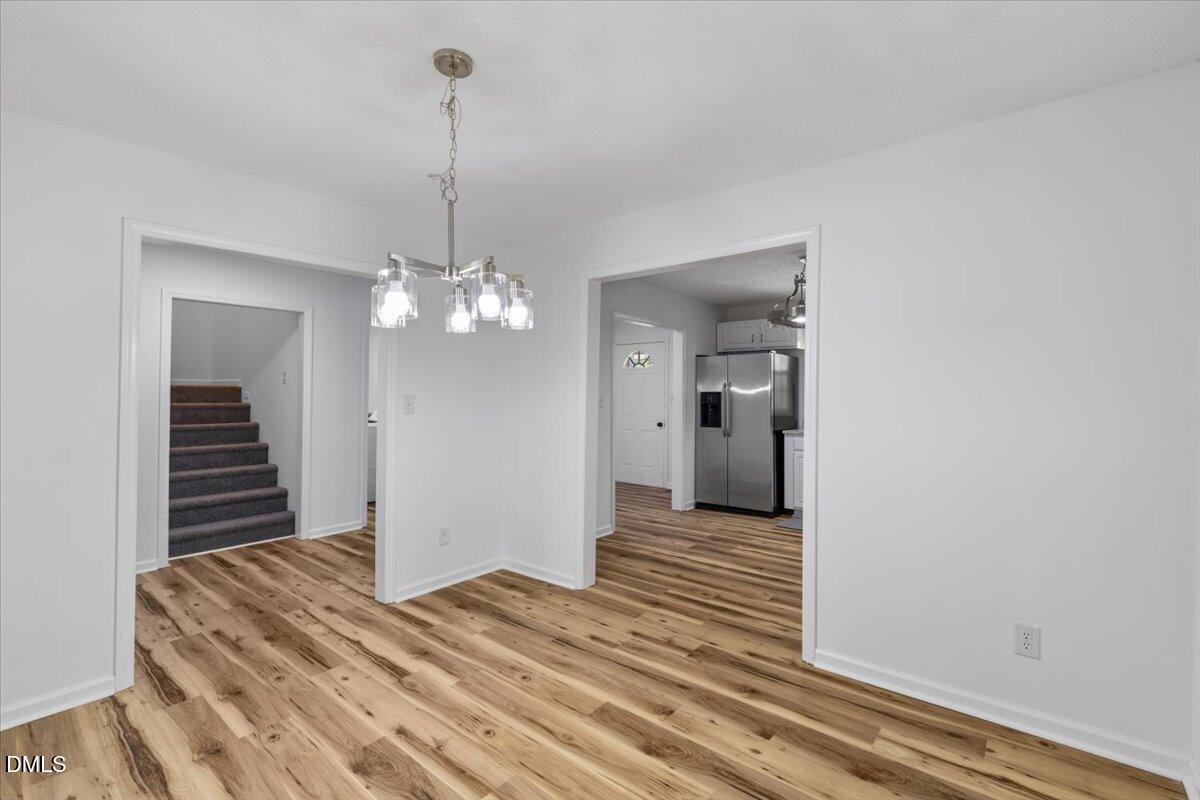 836 South Main Street Roxboro, NC 27573 - Photo 15 of 55 a view of a room with wooden floor and ceiling fan