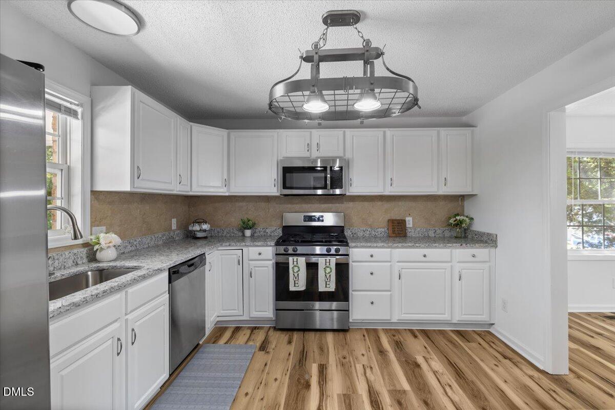 836 South Main Street Roxboro, NC 27573 - Photo 18 of 55 a kitchen with a sink stainless steel appliances and cabinets