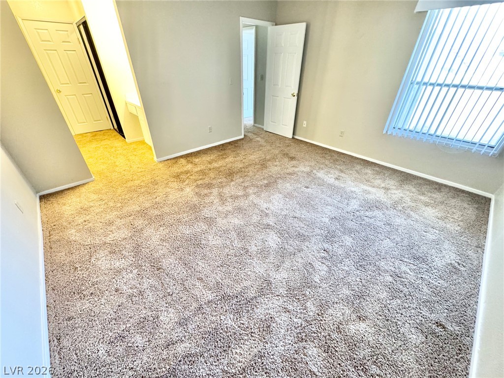 6250 West Flamingo Road, Unit 109 Las Vegas, NV 89103 - Photo 8 of 18 A spacious room offers comfortable carpeted flooring and ample natural light.