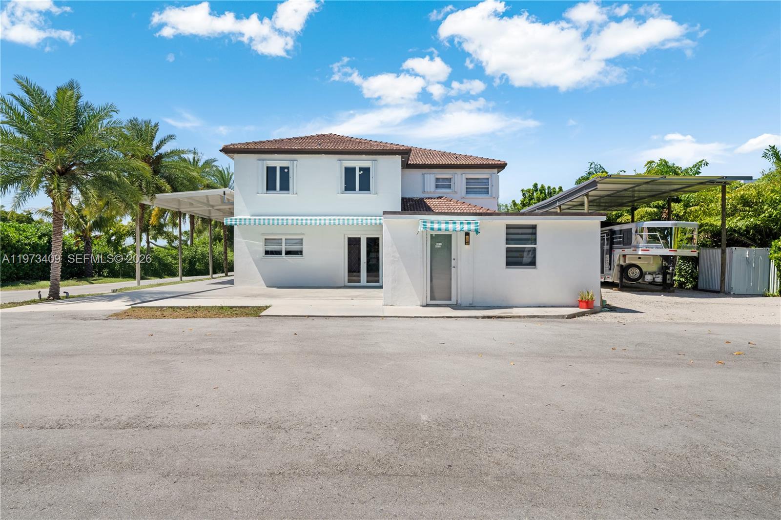 13050 Southwest 26th Street Miami, FL 33175 - Photo 28 of 43 a view of a house with a outdoor space and palm trees