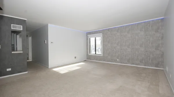 en empty room with wooden floor and ceiling fan