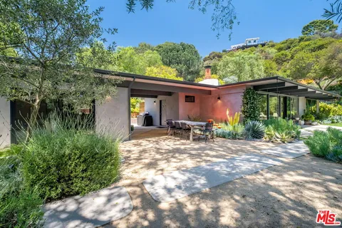 an aerial view of house with trees all around