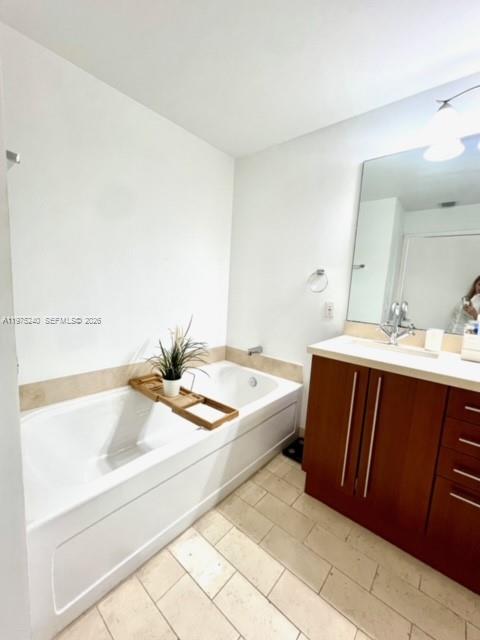 79 Southwest 12th Street, Unit 2010 Miami, FL 33130 - Photo 12 of 20 a bathroom with a tub sink and a mirror