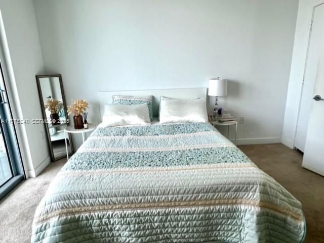 79 Southwest 12th Street, Unit 2010 Miami, FL 33130 - Photo 15 of 20 a bedroom with a bed and wooden floor