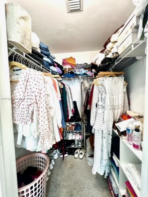 79 Southwest 12th Street, Unit 2010 Miami, FL 33130 - Photo 16 of 20 a view of walk in closet with clothes and shoes