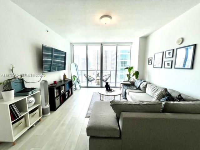79 Southwest 12th Street, Unit 2010 Miami, FL 33130 - Photo 3 of 20 a living room with furniture and a flat screen tv