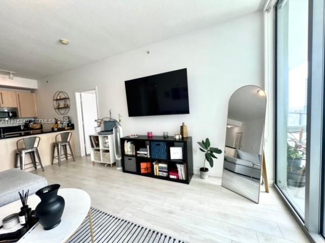 79 Southwest 12th Street, Unit 2010 Miami, FL 33130 - Photo 6 of 20 a living room with furniture and a flat screen tv