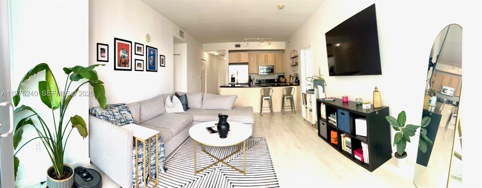 79 Southwest 12th Street, Unit 2010 Miami, FL 33130 - Photo 7 of 20 a living room with furniture and a flat screen tv