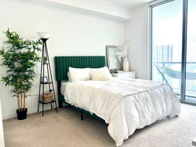 79 Southwest 12th Street, Unit 2010 Miami, FL 33130 - Photo 9 of 20 a bedroom with a bed and a potted plant