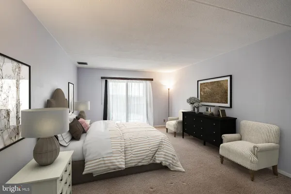 a bedroom with a bed and a couch