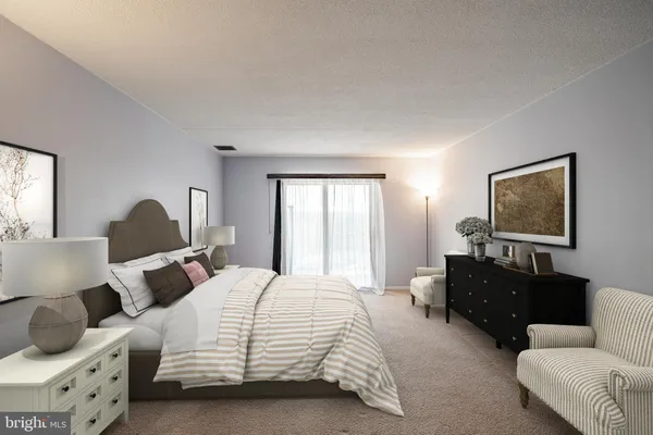 a bedroom with bed and a couch