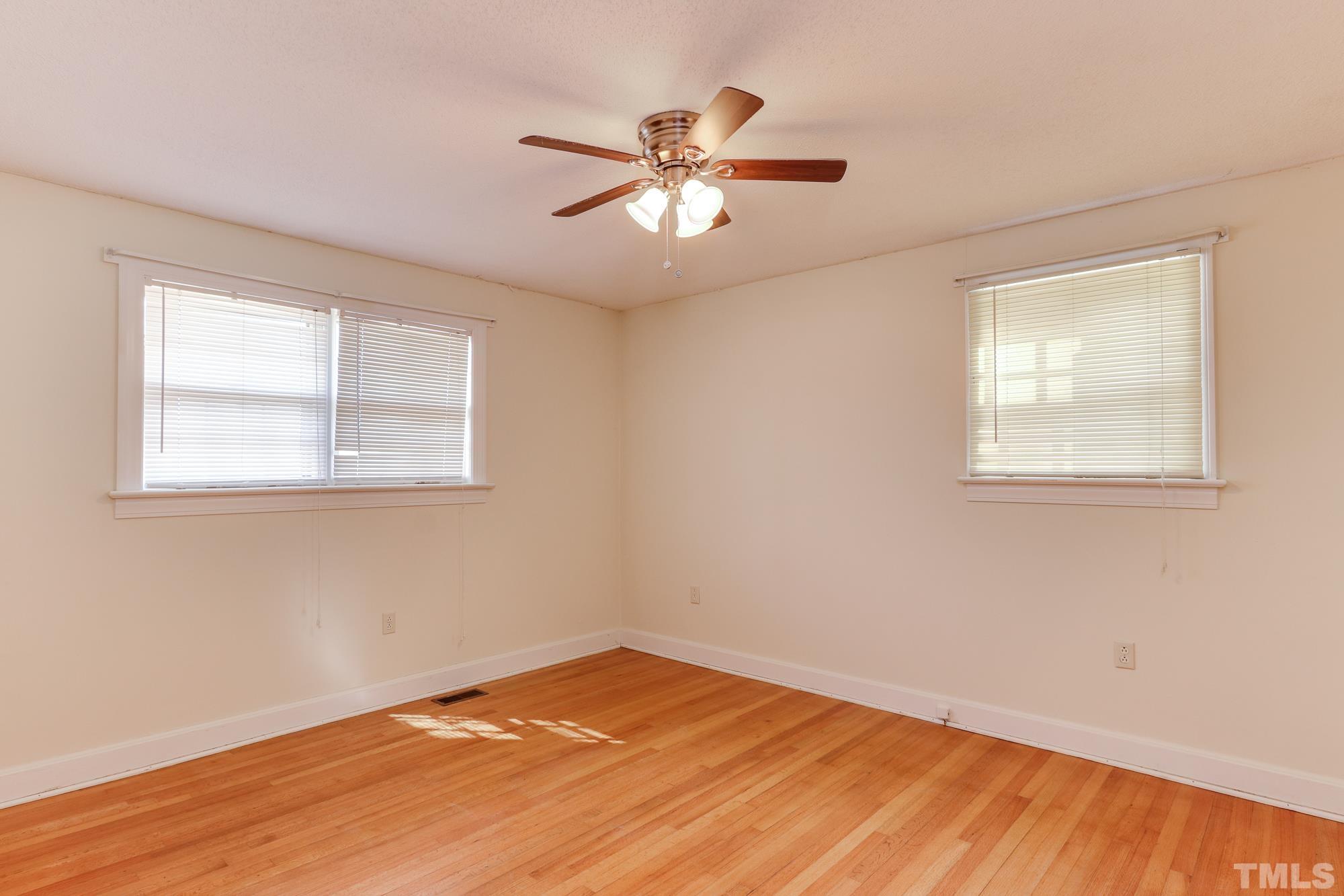 11723 Claude Lewis Road Middlesex, NC 27557 - Photo 18 of 27 a view of an empty room with wooden floor and a window