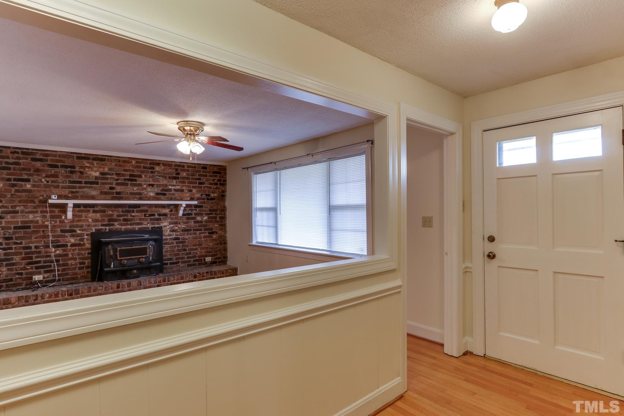11723 Claude Lewis Road Middlesex, NC 27557 - Photo 3 of 27 a view of a livingroom with a fireplace and wooden floor