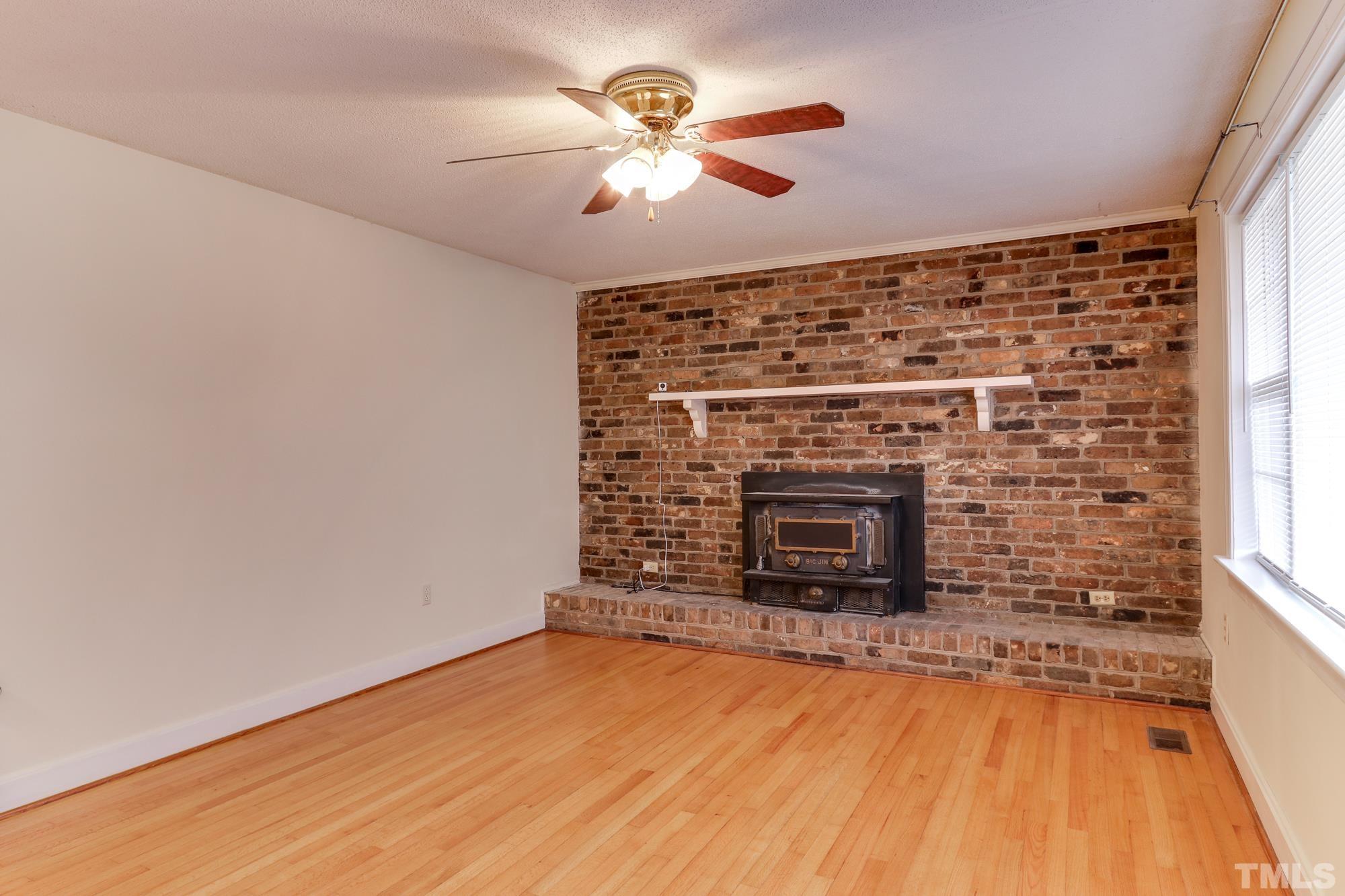 11723 Claude Lewis Road Middlesex, NC 27557 - Photo 4 of 27 wooden floor fireplace and window in an empty room