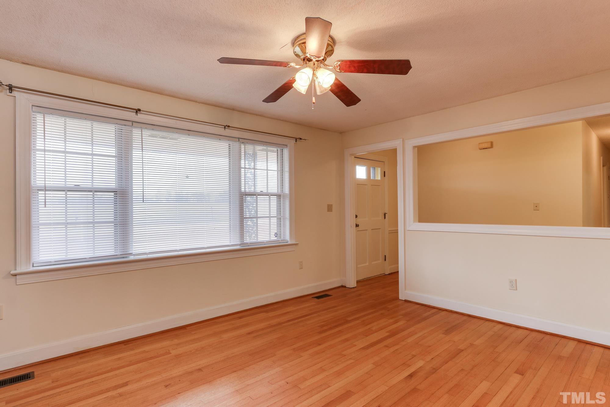 11723 Claude Lewis Road Middlesex, NC 27557 - Photo 6 of 27 a view of an empty room with wooden floor and a window