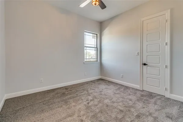 a bathroom with a granite countertop toilet a sink and a mirror