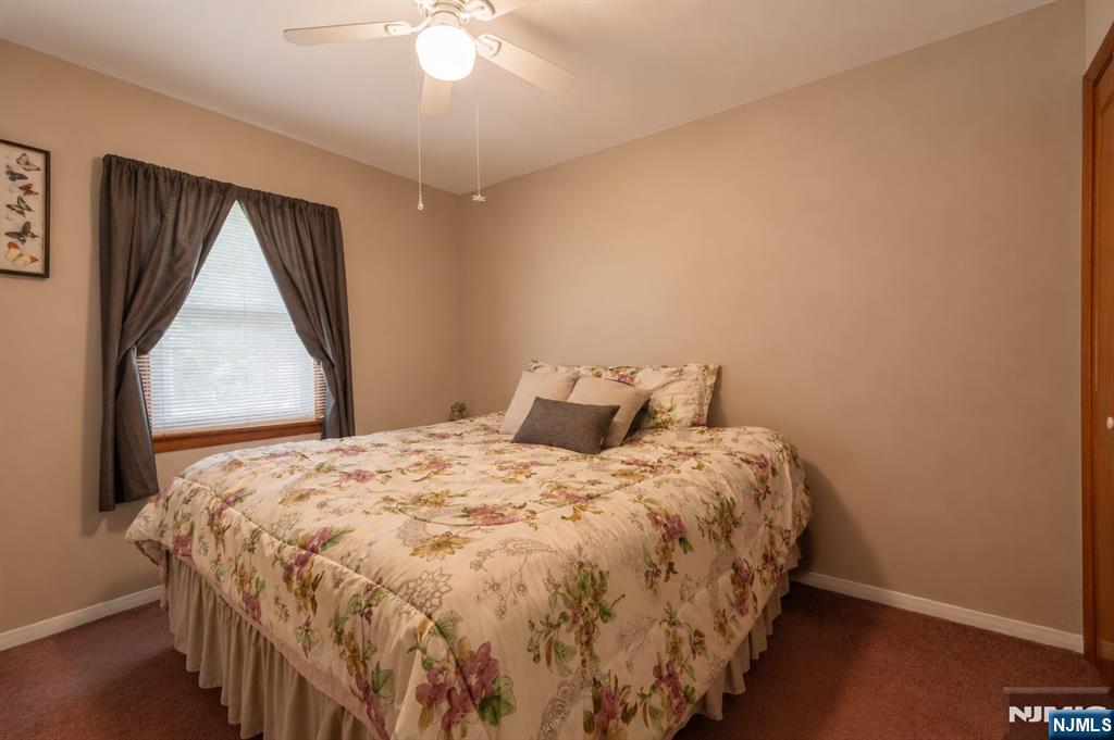 55 Marcia Road Ringwood, NJ 07456 - Photo 18 of 42 a bed sitting in a bedroom next to a window
