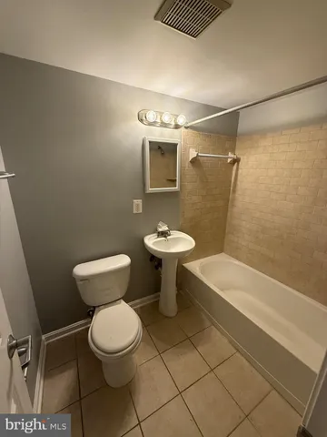 a bathroom with a toilet a sink and bathtub