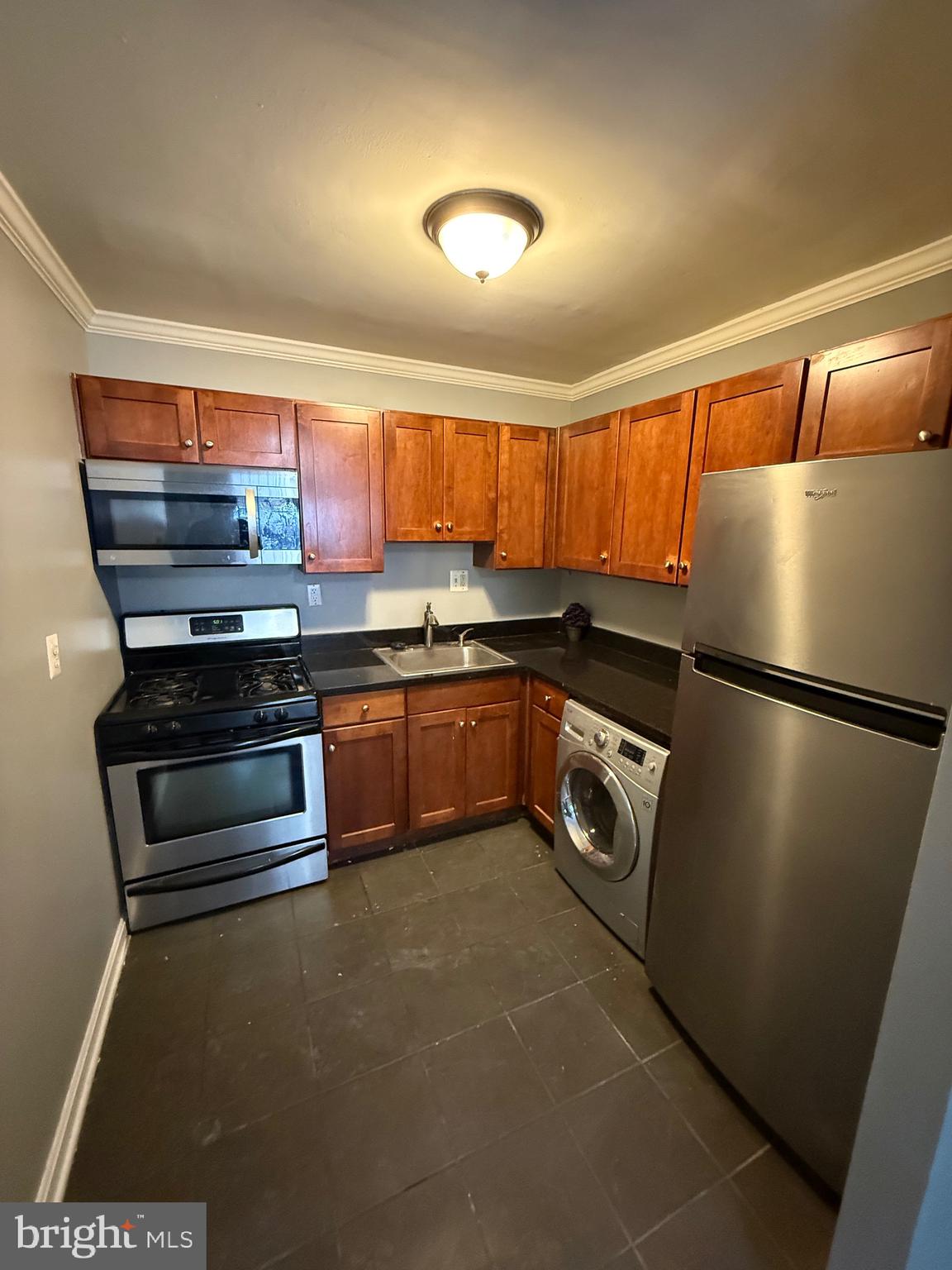 3101 Naylor Road Southeast, Unit 104 Washington, DC 20020 - Photo 8 of 13 a kitchen with stainless steel appliances and a sink