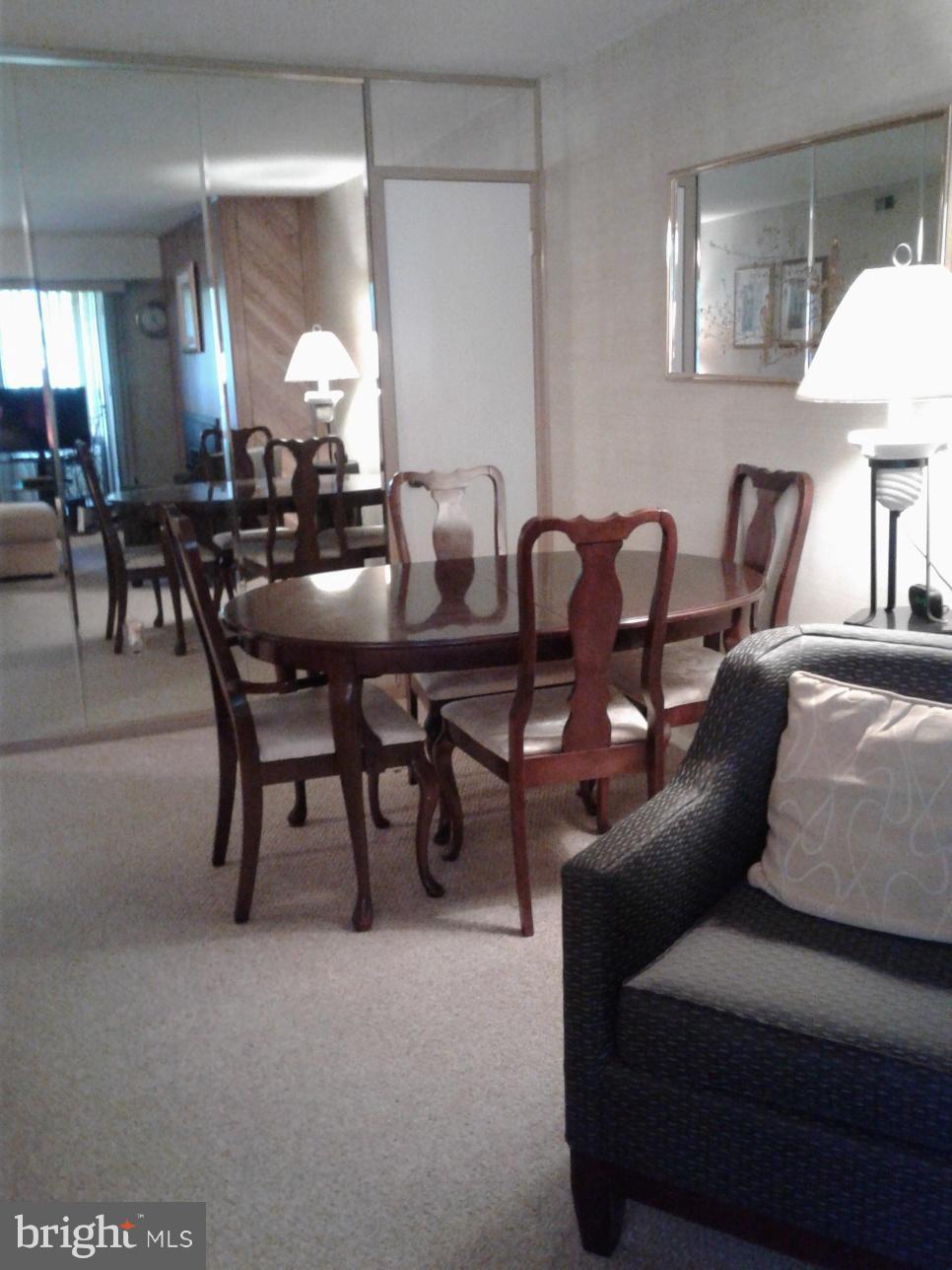 5717 Harpers Farm Road, Unit E Columbia, MD 21044 - Photo 11 of 21 a living room with furniture a lamp and a painting