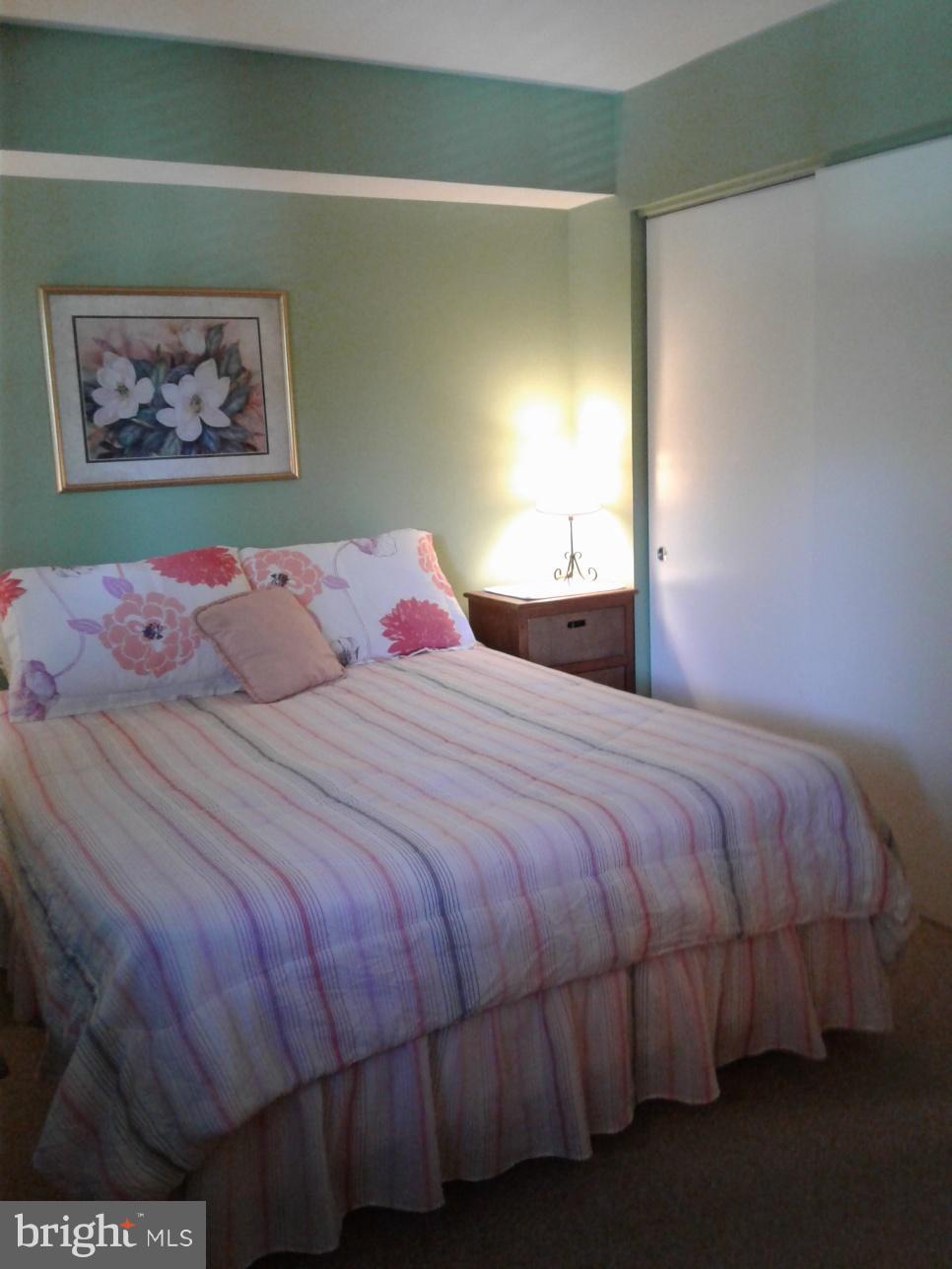 5717 Harpers Farm Road, Unit E Columbia, MD 21044 - Photo 19 of 21 a bedroom with a bed and a painting on the wall