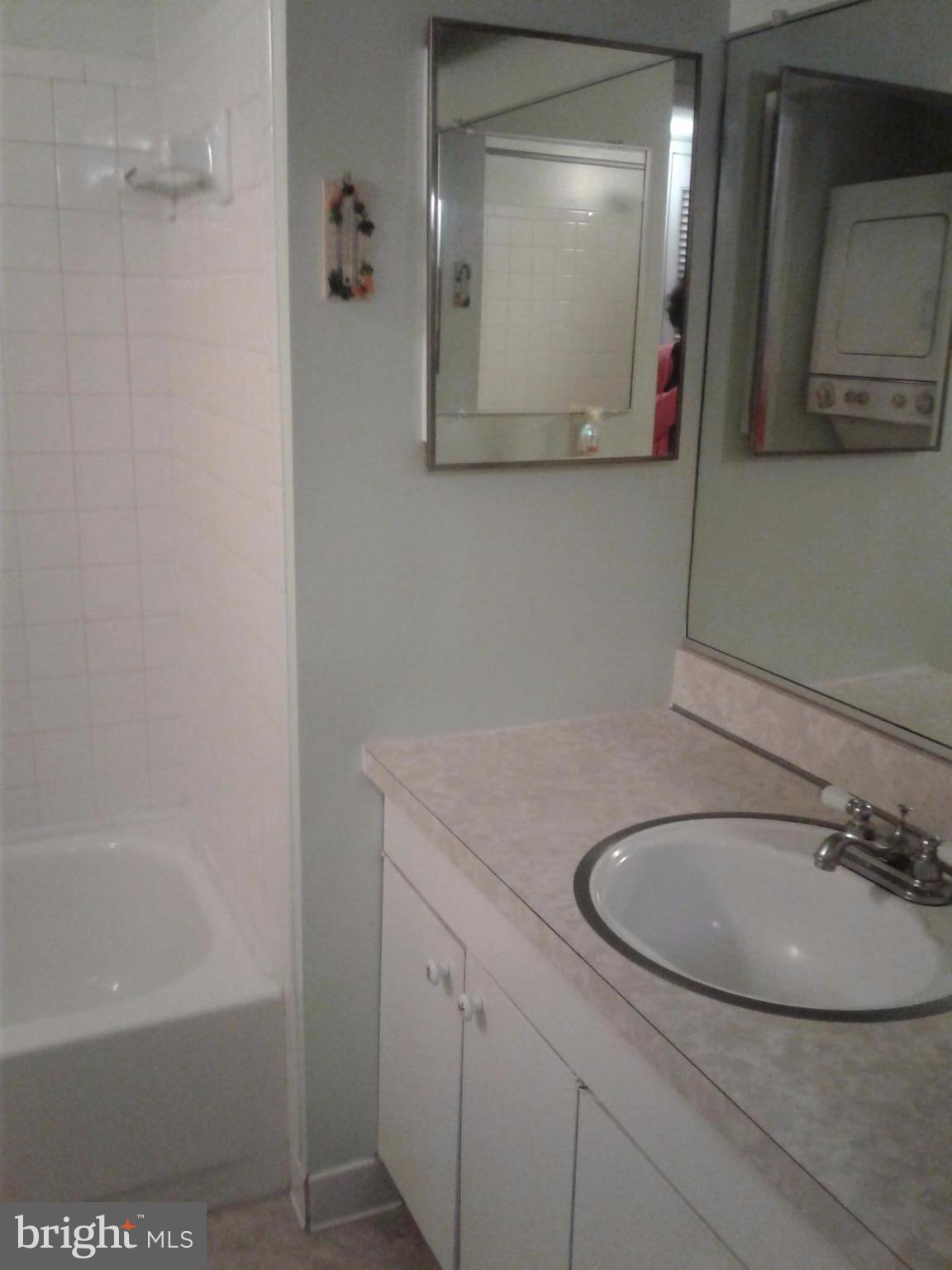 5717 Harpers Farm Road, Unit E Columbia, MD 21044 - Photo 21 of 21 a bathroom with a sink and a mirror